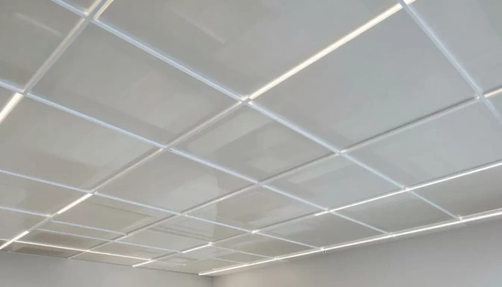 A modern suspended ceiling with integrated lighting.